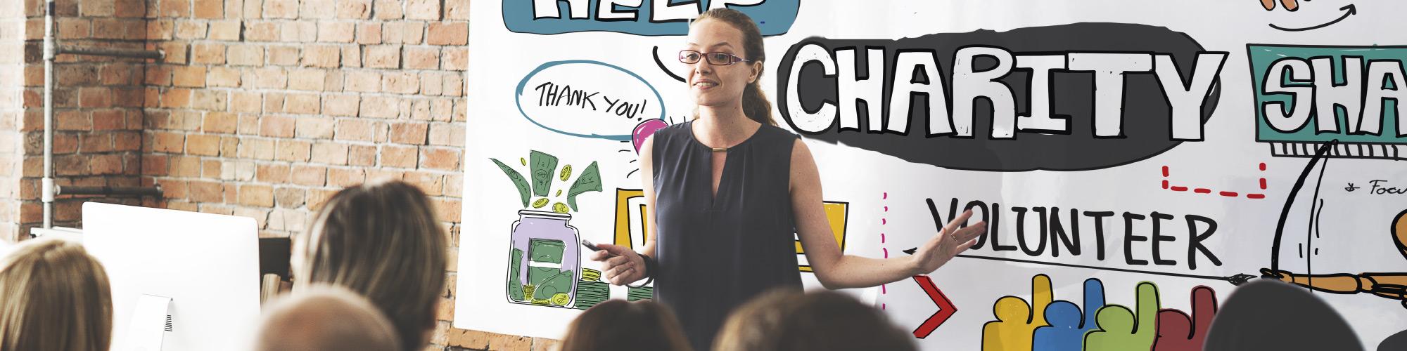 Lady speaking to a crowd about charity