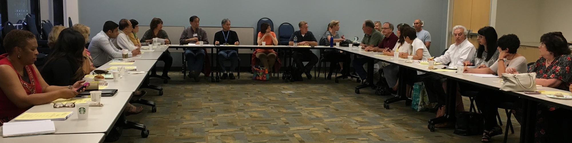 group of people around a table having a meeting