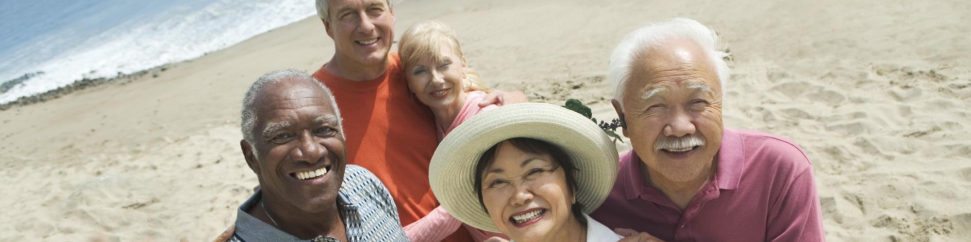 diverse group of seniors on the beach