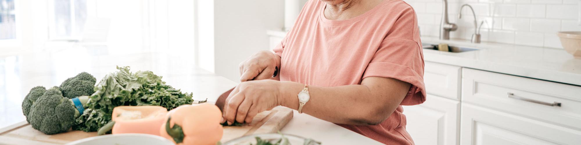 elderly lady cutting vegetables
