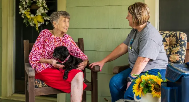 image of two seated ladies talking