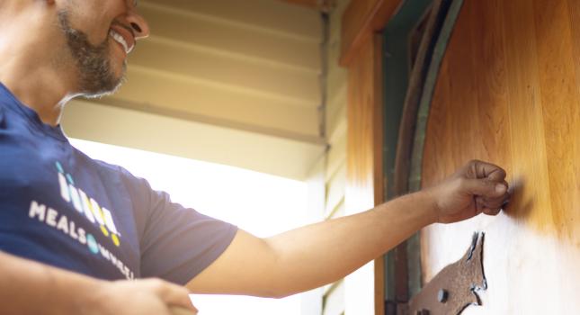 image of a man knocking on a door