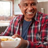 african american passing a bowl of food